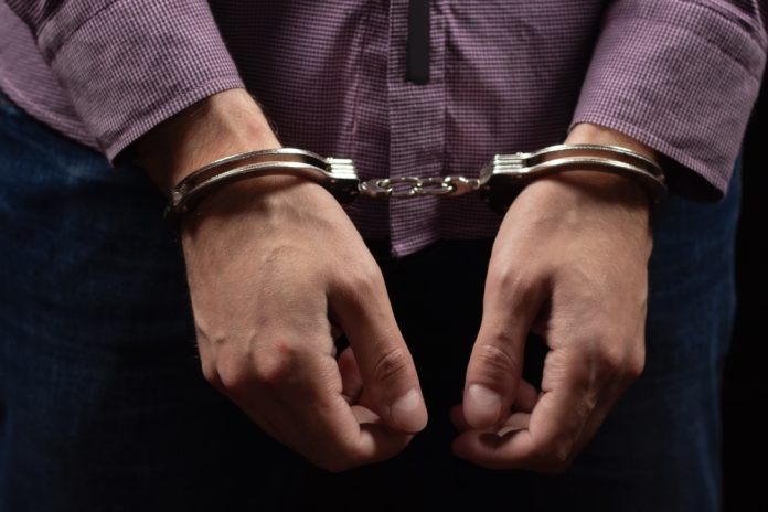 2467324329 featured image Person wearing handcuffs on their wrists