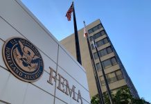 FEMA building with flags and blue sky backdrop