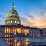 US Capitol building illuminated at sunset