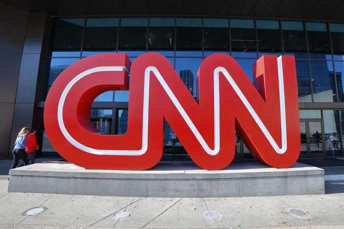 1568712067 Large red CNN sign outside building entrance.