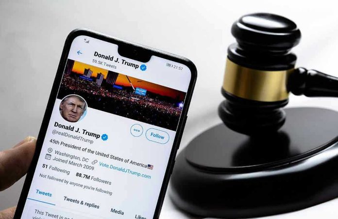 1889360596 Smartphone displaying Twitter profile near a judge's gavel.
