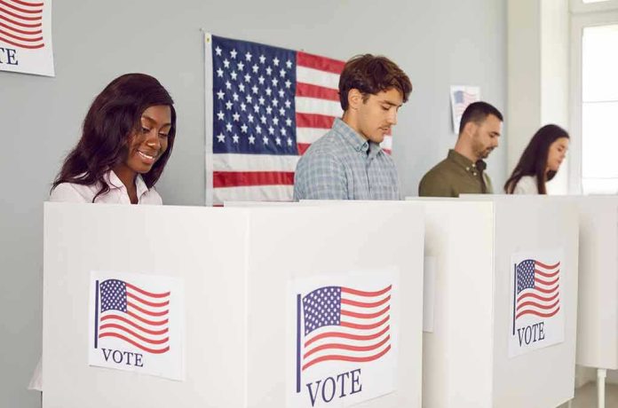 2360884499 People voting in booths with American flag backdrop.