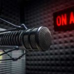 Radio microphone in studio with On Air sign.