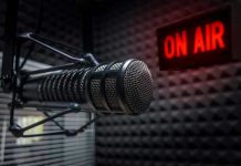 Radio microphone in studio with On Air sign.