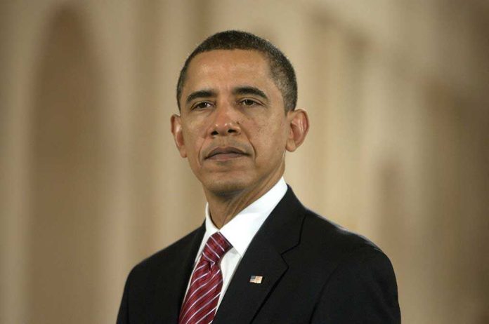 Formal portrait of a political figure in a suit with a serious expression