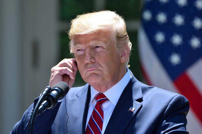 1528474766 Man in a suit adjusting an earpiece.