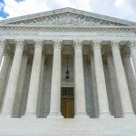 Trump DEMANDS SCOTUS Intervene – He’s Serious Building with columns under a cloudy sky.