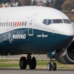 Boeing 737 MAX airplane on runway.