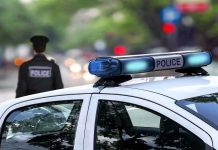 Suspect Outsmarts ENTIRE Police Dept – In Plain Sight! Police car and officer on a city street.