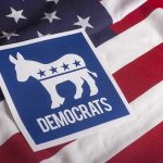 Nazi Tattoo Shocker: Senate Campaign Explodes Democratic Party symbol on American flag background.