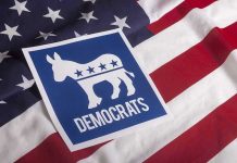 Nazi Tattoo Shocker: Senate Campaign Explodes Democratic Party symbol on American flag background.