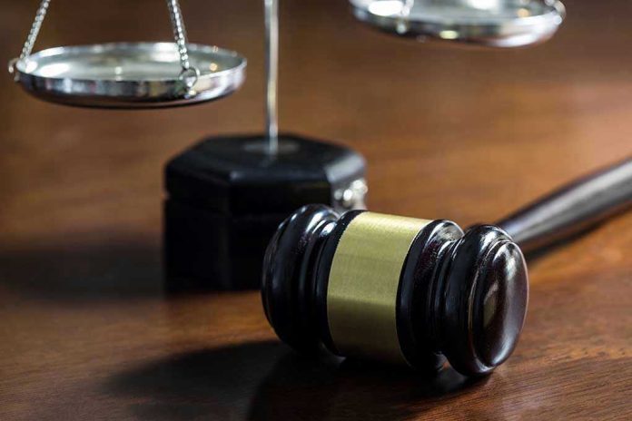 526372696 Gavel and scales of justice on wooden table.