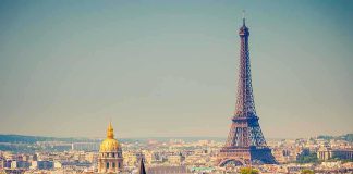 A panoramic view of Paris featuring the Eiffel Tower and a golden dome
