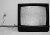 A vintage television displaying static on the screen