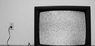 A vintage television displaying static on the screen