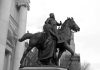 Bronze equestrian statue of a historical figure with a woman beside him