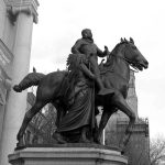 Bronze equestrian statue of a historical figure with a woman beside him