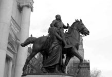 Bronze equestrian statue of a historical figure with a woman beside him