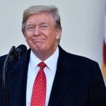 Trump SUMMONS Mamdani – Sets Up Meeting Man in suit and tie speaking at podium.