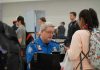 $10,000 Paydays Stun TSA Veterans TSA agent checks passengers documents at airport security.
