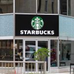 Starbucks Boycott Chaos — Workers Revolt Nationwide Starbucks storefront with glass doors and logo