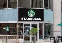 Starbucks Boycott Chaos — Workers Revolt Nationwide Starbucks storefront with glass doors and logo
