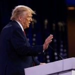 Comey, James Indictment Implodes – Trump VOWS Revenge Person speaking at a podium with hand raised