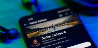 Furious Backlash: Carlson Faces GOP Wrath! Smartphone displaying a YouTube channel profile page.