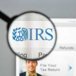 Magnifying glass over IRS website.
