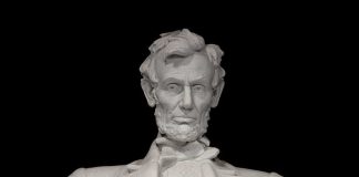 Marble statue of Abraham Lincoln seated with a serious expression