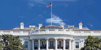 White House Dares $50 Million Bounty Reward The White House with the American flag flying against a blue sky