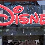 HORRIFYING Disney Crisis — Four Dead, Zero Answers Bright red Disney logo displayed on a storefront window