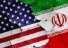 Iran President Declares TOTAL WAR on America Cracked American and Iranian flags on a wall.