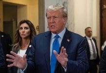 Trump Suffers SETBACK: No Prosecutor Role for Ally Man speaking with hands raised, woman and security behind.