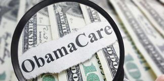 Magnifying glass over Obamacare text and money