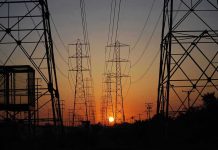 City Grid Fails – Total Blackout Horror! Transmission towers at sunset.
