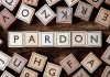 Trump Clemency BACKFIRES – Recipient Goes ROGUE Wooden letter blocks arranged to spell 'PARDON' on a wooden surface