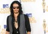 A man with long hair and sunglasses posing at the MTV Movie Awards