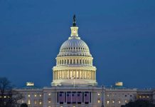 MIDNIGHT Shutdown Begins – Congress Missing In Action U.S. Capitol building illuminated at dusk.