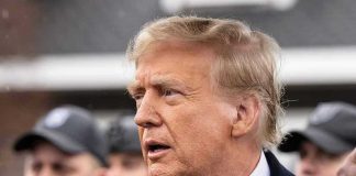 Trump’s NUCLEAR Attack on Congresswoman Stuns Room Man in suit and red tie speaking outside.