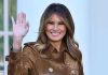 Box Office Shock: “Melania” STUNS! Person smiling and waving wearing a brown coat