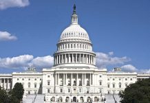 U.S. Capitol building against blue sky.