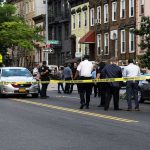 Police gathered at an urban crime scene.