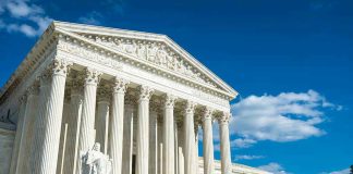 SCOTUS Takes Case, 150-Year Law Under Threat Building with columns under a blue sky.