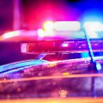 Police car lights flashing at night.