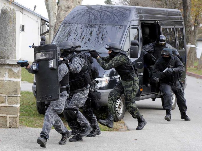 SWAT team members in tactical gear responding to a situation