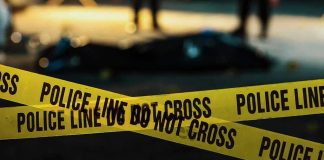Police tape marking a crime scene at night.