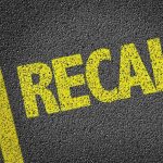 700K Cars RECALLED – Severe Safety Risk! Yellow RECALL text on asphalt background.