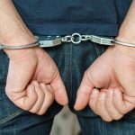 Mystery Surrounds Arrest of Paul Hogan’s Son Person in handcuffs behind their back.