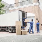 FAKE Job Offer Leads to Tragic Murder Workers unloading boxes from a moving truck in a residential driveway